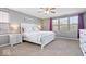 Comfortable bedroom with abundant natural light, neutral colors and a ceiling fan at 1815 Kingen Dr, Greenfield, IN 46140