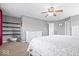 Bedroom features neutral colors, ceiling fan, open shelving, and a dresser for ample storage at 1815 Kingen Dr, Greenfield, IN 46140