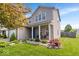 Charming two-story home features a covered porch with seating and well-maintained landscaping at 1815 Kingen Dr, Greenfield, IN 46140