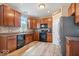 Well-equipped kitchen featuring wood cabinets, modern appliances, and a tile backsplash at 1815 Kingen Dr, Greenfield, IN 46140