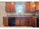 Kitchen features wood cabinets, stainless steel sink, and under cabinet drawers at 1815 Kingen Dr, Greenfield, IN 46140