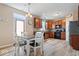 Open kitchen area with wooden cabinets, breakfast table, and modern appliances at 1815 Kingen Dr, Greenfield, IN 46140