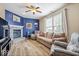 Comfortable living room featuring hardwood flooring, a brick fireplace, and bright accent wall at 1815 Kingen Dr, Greenfield, IN 46140