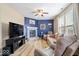 Comfortable living room with cozy fireplace, ceiling fan, and neutral decor at 1815 Kingen Dr, Greenfield, IN 46140