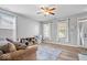 Bright living room with neutral walls, wood floors, large windows, and a cozy seating area at 1815 Kingen Dr, Greenfield, IN 46140