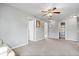 Spacious living room featuring neutral walls, multiple doorways, and a ceiling fan for added comfort at 1815 Kingen Dr, Greenfield, IN 46140