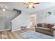 Open concept living space with wood floors and plush seating, bathed in natural light at 1815 Kingen Dr, Greenfield, IN 46140