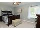 Well-lit bedroom with a queen bed, neutral carpet, and a large window at 199 Three Notch Ln, Bargersville, IN 46106