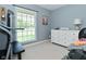 Bedroom with large window, white dresser, weights and neutral carpeting at 199 Three Notch Ln, Bargersville, IN 46106