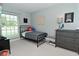 Light-filled bedroom with a full-size bed, cartoon decor and large window with blinds at 199 Three Notch Ln, Bargersville, IN 46106