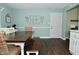 Kitchen-dining area with wood laminate floors, a rustic wood table and backyard access at 199 Three Notch Ln, Bargersville, IN 46106