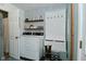 Laundry room with modern patterned wallpaper, and hall tree shoe rack and storage at 199 Three Notch Ln, Bargersville, IN 46106