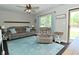 Cozy living room with neutral walls, light blue rug, ceiling fan and comfortable furniture at 199 Three Notch Ln, Bargersville, IN 46106
