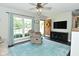 Bright living room with wood laminate flooring, TV, plush seating and view of front yard at 199 Three Notch Ln, Bargersville, IN 46106