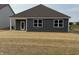 View of the home's rear exterior and yard space, providing a glimpse of the outdoor living potential at 2047 Quail W Dr, Danville, IN 46122
