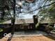 Private backyard with a small patio, mature trees, and a fence, providing space for relaxation and outdoor activities at 209 Brighton Ct, Greenwood, IN 46143