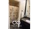 Traditional bathroom showcasing a vanity with dark cabinets, granite countertop, and shower with a patterned curtain at 209 Brighton Ct, Greenwood, IN 46143