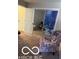 Carpeted bedroom featuring a mirrored closet with a decorative ocean pattern on the doors and a sitting chair at 209 Brighton Ct, Greenwood, IN 46143
