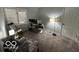 Bedroom with a window, carpet, rocking chair, and desk setup at 209 Brighton Ct, Greenwood, IN 46143