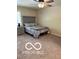 Neutral bedroom with a gray upholstered headboard, matching nightstand and dresser, and carpeted floor at 209 Brighton Ct, Greenwood, IN 46143