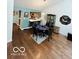 Open dining area adjacent to the kitchen with hardwood floors and modern decor at 209 Brighton Ct, Greenwood, IN 46143
