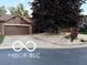 Charming home featuring a two-car garage, mature tree, and concrete driveway at 209 Brighton Ct, Greenwood, IN 46143