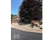 The exterior boasts a huge tree in a landscaped front yard and attached two-car garage at 209 Brighton Ct, Greenwood, IN 46143