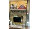 A stone fireplace featuring a wooden mantle and decorative items at 209 Brighton Ct, Greenwood, IN 46143