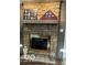 Stone fireplace with wood mantle and decorative items at 209 Brighton Ct, Greenwood, IN 46143