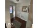 Inviting foyer with hardwood floors, a decorative front door and lovely rug at 209 Brighton Ct, Greenwood, IN 46143