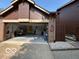 View of the open garage, a brick facade, and an adjacent privacy fence at 209 Brighton Ct, Greenwood, IN 46143