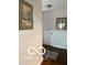 Simple hallway with wood flooring, decorated with two framed paintings on the neutral walls at 209 Brighton Ct, Greenwood, IN 46143