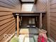 Inviting covered patio with seating, wood decking, and charming decorative accents at 209 Brighton Ct, Greenwood, IN 46143