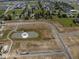 An aerial view of a new housing development with ponds, future lots, and landscaping at 2143 Warbler St, Danville, IN 46122