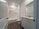 Bright bathroom with a shower-tub combo, featuring a single vanity and hardwood floors at 2159 Warbler St, Danville, IN 46122