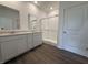 Bathroom featuring dual sinks, a glass shower, quartz countertops, and hardwood floors at 2159 Warbler St, Danville, IN 46122