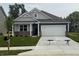 Charming single Gathering home with grey and navy siding and a two car garage at 2159 Warbler St, Danville, IN 46122
