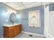 Bathroom featuring a stylish vanity with a sleek sink, complemented by a well-lit mirror and tiled floors at 2319 S I St, Elwood, IN 46036