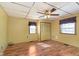 Comfortable bedroom with wood-look flooring, natural light, and classic ceiling fan for added comfort at 2319 S I St, Elwood, IN 46036