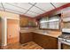 Well-lit kitchen with stainless steel sink, wood cabinets, and tiled backsplash for a charming cooking experience at 2319 S I St, Elwood, IN 46036