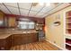 Functional kitchen includes stainless steel oven and dark wood cabinetry at 2319 S I St, Elwood, IN 46036