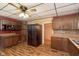 Spacious kitchen featuring stainless steel refrigerator, ample cabinetry, and a stylish ceiling fan at 2319 S I St, Elwood, IN 46036