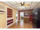 This kitchen shows built in shelving, laminate floors and a view to the bathroom at 2319 S I St, Elwood, IN 46036
