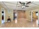 Open living room has laminate floors, neutral walls, and a view into other rooms at 2319 S I St, Elwood, IN 46036