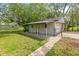 View of the backyard with a white shed, a lawn, and a chain link fence at 2321 W 26Th St, Anderson, IN 46016
