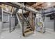 Unfinished basement with exposed piping, ductwork, and utilities offering potential for customization at 2321 W 26Th St, Anderson, IN 46016