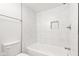 Bright bathroom features a modern bathtub with a white marbled tile surround and storage nook at 2321 W 26Th St, Anderson, IN 46016