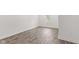 Bright bedroom features new hardwood floors, white walls, base trim, window with blinds, and neutral decor at 2321 W 26Th St, Anderson, IN 46016