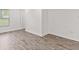 Bright bedroom features new hardwood floors, white walls, base trim, window with blinds, and neutral decor at 2321 W 26Th St, Anderson, IN 46016