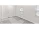 An empty bedroom with light grey carpet, white walls, a door, and two windows at 2321 W 26Th St, Anderson, IN 46016